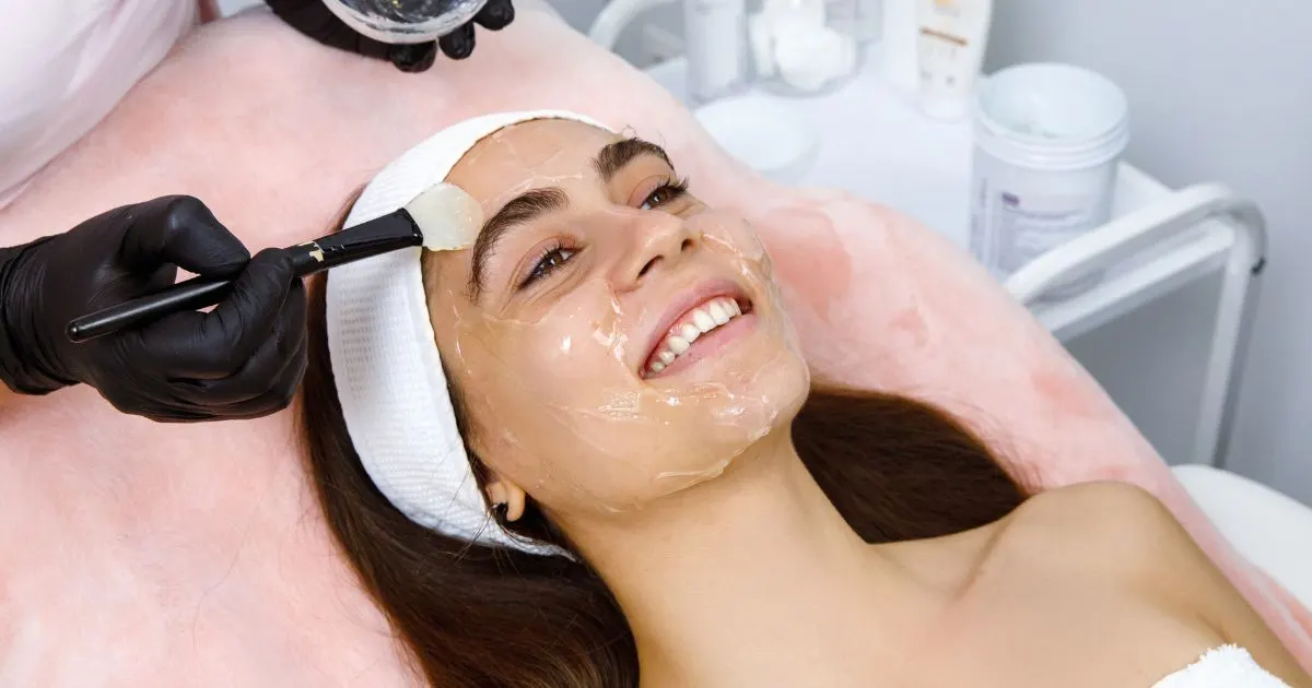 Applying sunscreen to protect skin before a chemical peel treatment in Forest Hills NY