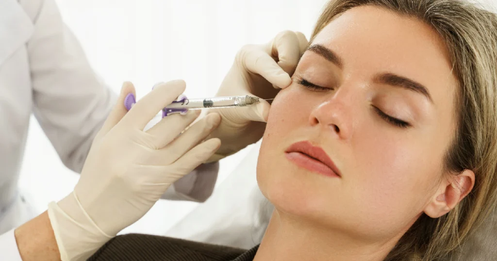 Woman receiving Botox in Forest Hills, NY from a medical professional, focusing on the injection near her cheek